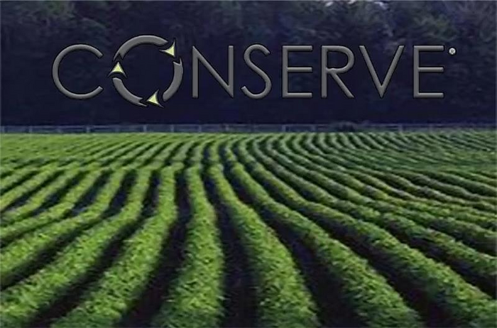 Field with rows of crops and 'Conserve' logo in the background